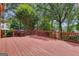 Spacious stained deck with wood railings, perfect for outdoor entertaining with lush green surroundings at 821 Carnellian Ln, Peachtree City, GA 30269
