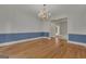 Spacious dining room with hardwood floors and classic chandelier at 821 Carnellian Ln, Peachtree City, GA 30269