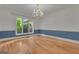 Dining room with large windows, chandelier, and hardwood floors at 821 Carnellian Ln, Peachtree City, GA 30269