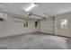 This shows an inside garage with a garage door, concrete flooring, a window, and access to the inside at 821 Carnellian Ln, Peachtree City, GA 30269