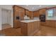 Traditional kitchen features wood cabinets, island, stainless steel appliances, and hardwood floors at 821 Carnellian Ln, Peachtree City, GA 30269