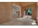 Open concept living room with wood paneled walls and a view into the kitchen and upper floor at 821 Carnellian Ln, Peachtree City, GA 30269