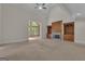 Open-concept living area with fireplace, built-in shelves, and plenty of natural light at 821 Carnellian Ln, Peachtree City, GA 30269