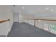 View of open loft space overlooking the yard and lower level at 821 Carnellian Ln, Peachtree City, GA 30269