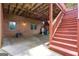 Covered patio area with brick walls and a wooden staircase, offering outdoor space with utility installations at 821 Carnellian Ln, Peachtree City, GA 30269