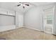 Bedroom with carpet, ceiling fan, ample natural light, and built-in shelving at 1220 Roswell Manor Cir, Roswell, GA 30076
