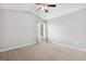 Bedroom with vaulted ceiling featuring neutral carpet, ceiling fan and view to the backyard at 1220 Roswell Manor Cir, Roswell, GA 30076