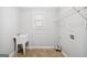 Functional laundry room with utility sink, storage shelves, and tiled floor at 1220 Roswell Manor Cir, Roswell, GA 30076