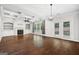 Bright living room with fireplace, custom built-ins, and French doors leading to the patio at 1220 Roswell Manor Cir, Roswell, GA 30076