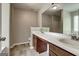 Bathroom with double vanity sinks, a large mirror, and neutral tones at 2504 Plymouth Way, Conyers, GA 30013