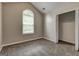 This bedroom boasts plush gray carpeting, closet, and a bright window offering natural light at 2504 Plymouth Way, Conyers, GA 30013