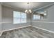 Dining room has a chandelier, views to the living room, and wood flooring at 2504 Plymouth Way, Conyers, GA 30013