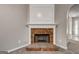 Close-up view of the brick fireplace with white mantle in the living room at 2504 Plymouth Way, Conyers, GA 30013