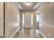 Bright foyer with a white front door and wood-look flooring, leading into carpeted rooms at 2504 Plymouth Way, Conyers, GA 30013