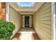 Inviting covered front porch with decorative trim and a dark front door, framed by lush greenery at 2504 Plymouth Way, Conyers, GA 30013