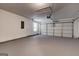 Spacious garage with neutral walls and flooring, includes an automatic door and side entry at 2504 Plymouth Way, Conyers, GA 30013
