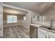 Stylish kitchen with stainless steel dishwasher and a view into the dining room at 2504 Plymouth Way, Conyers, GA 30013