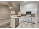 Well-lit kitchen with stainless steel dishwasher, white cabinets, and open floorplan at 2504 Plymouth Way, Conyers, GA 30013