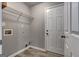 This laundry room includes wood-look flooring and a wire rack shelf for storage at 2504 Plymouth Way, Conyers, GA 30013