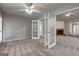 Light-filled living room features decorative doors and neutral carpeting at 2504 Plymouth Way, Conyers, GA 30013
