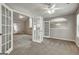 Open-concept living room with ceiling fan and decorative doors to other room at 2504 Plymouth Way, Conyers, GA 30013