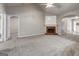 Expansive living room featuring neutral tones, soft carpeting, a fireplace, and multiple entryways at 2504 Plymouth Way, Conyers, GA 30013