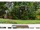 A spacious backyard features lush greenery and mature trees, perfect for outdoor activities at 640 Keys Ferry Rd, Mcdonough, GA 30252