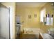 Bright bathroom featuring a soaking tub and updated fixtures at 640 Keys Ferry Rd, Mcdonough, GA 30252