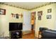 A cozy bedroom featuring yellow walls and classic floral wallpaper border at 640 Keys Ferry Rd, Mcdonough, GA 30252
