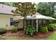 Home exterior highlighting a charming screened porch surrounded by lush landscaping at 640 Keys Ferry Rd, Mcdonough, GA 30252