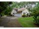 View of home's side and backyard, with a driveway and mature trees at 640 Keys Ferry Rd, Mcdonough, GA 30252