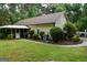 Home exterior features a screened-in porch, mature landscaping, and an inviting outdoor space for relaxation at 640 Keys Ferry Rd, Mcdonough, GA 30252