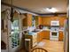 Kitchen with wood cabinets and white appliances at 640 Keys Ferry Rd, Mcdonough, GA 30252