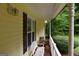 Cozy porch with a bench and view of landscaped yard at 640 Keys Ferry Rd, Mcdonough, GA 30252