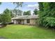 Charming single-story home with a well-manicured lawn and mature trees providing shade at 962 Brighton Dr, Lawrenceville, GA 30043
