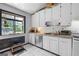 Well-lit kitchen with white cabinets, stainless steel appliances, and a large window at 962 Brighton Dr, Lawrenceville, GA 30043