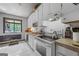 Bright kitchen features white cabinets, subway tile backsplash, and stainless steel appliances at 962 Brighton Dr, Lawrenceville, GA 30043