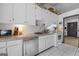 Functional kitchen featuring white subway tile, stainless steel dishwasher and ample countertop space at 962 Brighton Dr, Lawrenceville, GA 30043