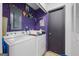 Laundry room with washer and dryer, storage, and door to exterior at 962 Brighton Dr, Lawrenceville, GA 30043