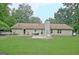 Spacious backyard featuring a well-maintained lawn, a patio, and view of the home with mature trees surrounding it at 210 Grandchester Way, Fayetteville, GA 30215
