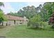 Backyard featuring a home with lush lawn, trees, and a chain-link fence at 210 Grandchester Way, Fayetteville, GA 30215