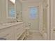 Updated bathroom features a double vanity, marble countertop, and a shower with a tub at 210 Grandchester Way, Fayetteville, GA 30215