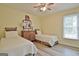 Comfortable bedroom features two twin beds, a wood floor, and a window at 210 Grandchester Way, Fayetteville, GA 30215