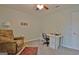 Comfortable bedroom with soft carpet, ceiling fan, seating, and a built-in desk at 210 Grandchester Way, Fayetteville, GA 30215
