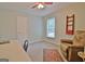 Bedroom featuring comfortable seating, shelving, and a large window for natural light at 210 Grandchester Way, Fayetteville, GA 30215