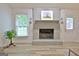Close up of fireplace and mantel with decorative sconces at 210 Grandchester Way, Fayetteville, GA 30215