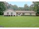 Well-maintained ranch home featuring a lush green lawn and beautiful landscaping at 210 Grandchester Way, Fayetteville, GA 30215