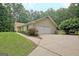 Side exterior view of home showing attached garage and walkway at 210 Grandchester Way, Fayetteville, GA 30215