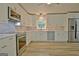 Renovated kitchen with stainless steel appliances, bright cabinets, and tile backsplash at 210 Grandchester Way, Fayetteville, GA 30215