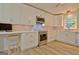 Well-lit kitchen featuring stainless appliances, breakfast bar, and wood floors at 210 Grandchester Way, Fayetteville, GA 30215